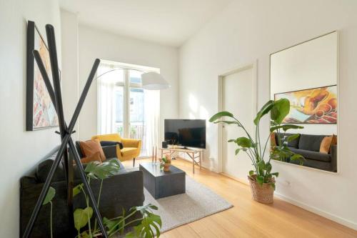 a living room with a couch and a tv at Top Location - Citycenter - Balcony in Copenhagen