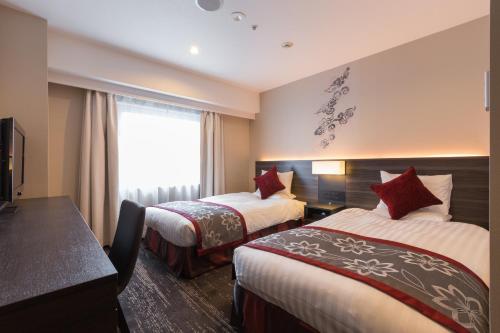 Postel nebo postele na pokoji v ubytování Matsue Excel Hotel Tokyu