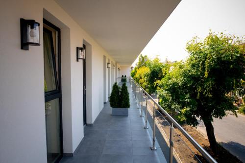 a hallway of a building with trees on it at Elixír Panzió in Nyírbátor