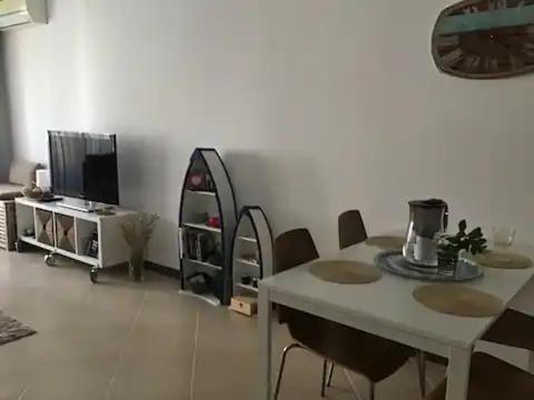 a living room with a table and chairs and a tv at Happy kids' vacation home in Lozenets