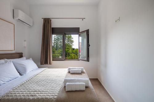 a bedroom with a bed with two towels on it at Angeliana Villa in Angeliana