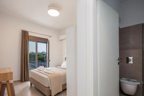 a bedroom with a bed and a bathroom at Angeliana Villa in Angeliana