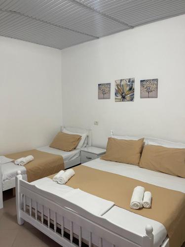 two beds in a room with two beds at Vogue Rooms in Golem