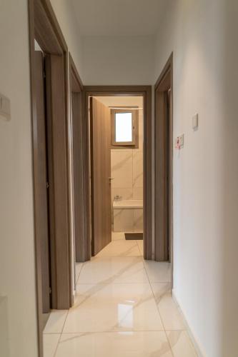 a corridor of a bathroom with a shower and a door at Hubstay - Seaview Villa Oriana in Larnaca, 10 min Walk to the Beach in Larnaka