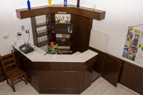 a counter in a restaurant with a phone in a room at Kokó Panzió in Harkány