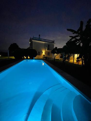a swimming pool with blue lighting in front of a building at Primavilla Relais in Gaeta