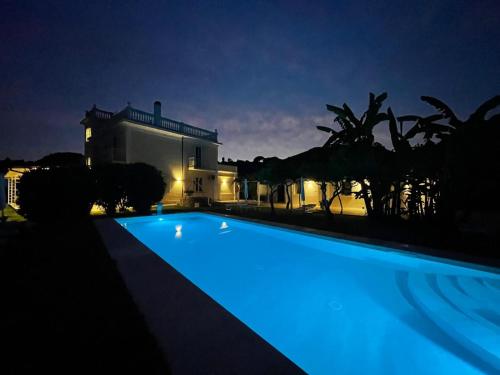 a swimming pool in front of a house at night at Primavilla Relais in Gaeta