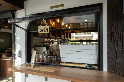 a store window with a open sign on it at Shamrock Chiangmai Hotel-Adult Only in Chiang Mai