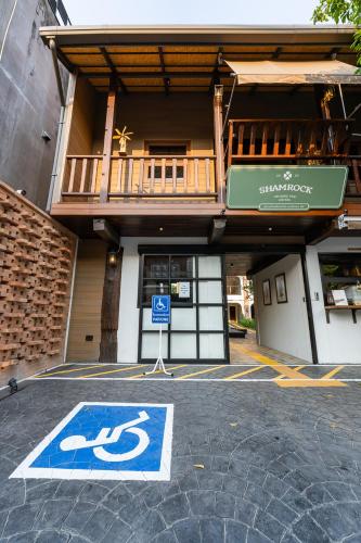 a handicapped parking sign in front of a building at Shamrock Chiangmai Hotel-Adult Only in Chiang Mai