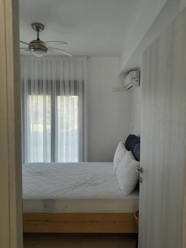 a bedroom with a bed with a window at Central House 2 in Ancient Epidauros