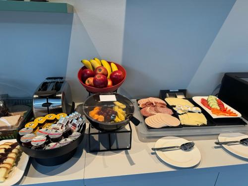 a table with a bunch of different types of food at GuestHouse Große Linde in Karlsruhe