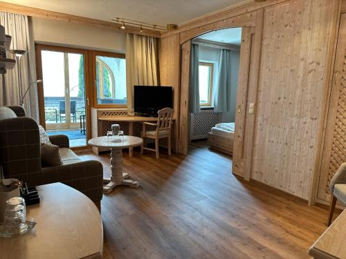 a living room with a couch and a table at Hotel Restaurant Neu Meran in Bad Reichenhall