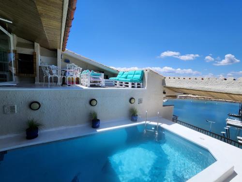 a swimming pool on the roof of a house at Solo Atico Guest Suites in L'Escala