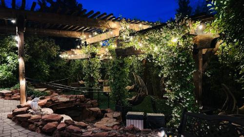 a garden with a pergola with ivy on it at Lantern Light Inn - Romantic Getaway in Sedona