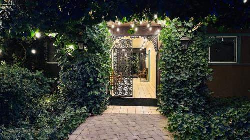 an entrance to a house with an open gate with ivy at Lantern Light Inn - Romantic Getaway in Sedona