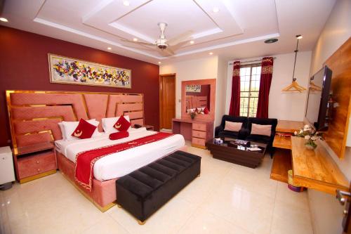 a bedroom with a large bed and a chair at Premier Inn Grand Gulberg Lahore in Lahore