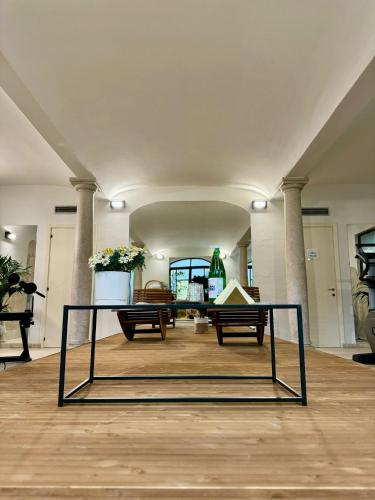 a large room with two benches and a table at Tenuta Il Poggio - Luxury B&B in Felegara
