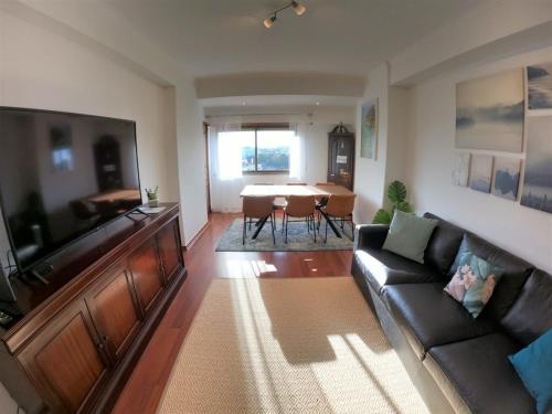 a living room with a couch and a table at Lisbon T2 apartment in condominium in Linda-a-Velha Oeiras Lisbon in Linda-a-Velha