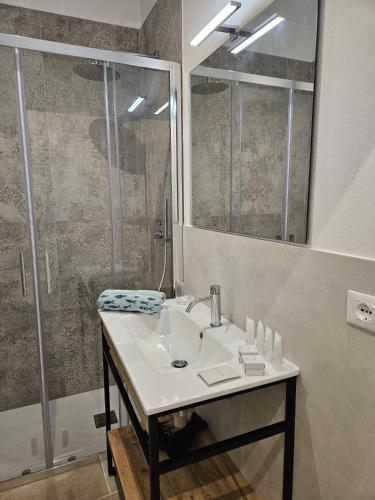 a bathroom with a sink and a shower at Joivy Dimore Rodiane - U Vucc'l in Rodi Garganico