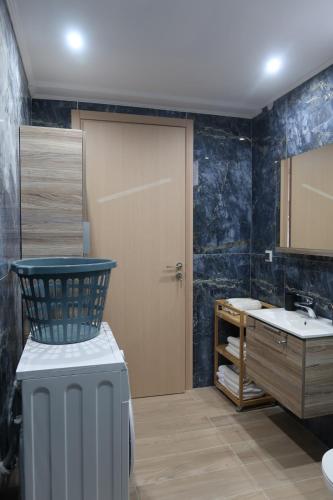 a bathroom with a toilet and a sink and a door at PARASCHOS APARTMENTS Kardamaina in Kos