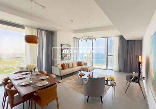 a living room with a table and chairs and a couch at Harmonious 3BR in Stella Maris, Sea View, Marina in Dubai