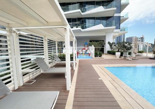 a balcony of a building with a swimming pool at Harmonious 3BR in Stella Maris, Sea View, Marina in Dubai