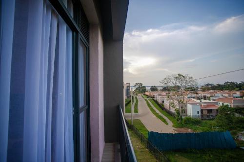 a window of a building with a view of a street at Iris Lakeside Condos in Entebbe in Entebbe