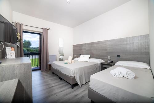A bed or beds in a room at Sardegna Termale Hotel&SPA