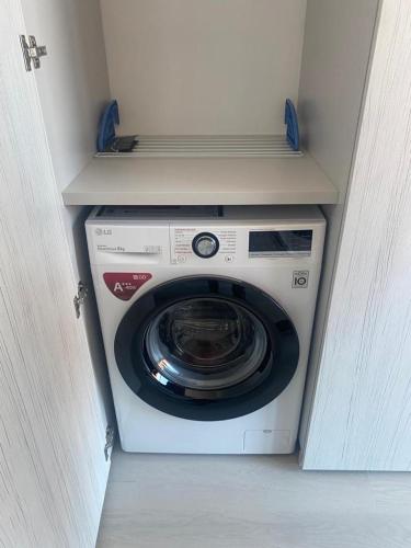 a washer and dryer in a cabinet in a room at Aveiro Sweet Twins in Aveiro