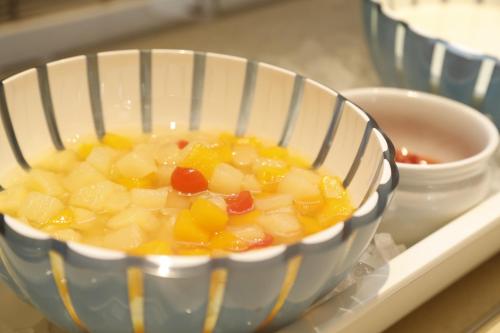 a bowl of soup sitting on a tray at Dormy Inn Maebashi in Maebashi