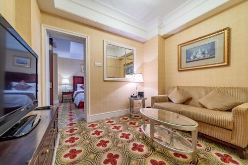 a living room with a couch and a table at Ramada Yichang Hotel in Yichang