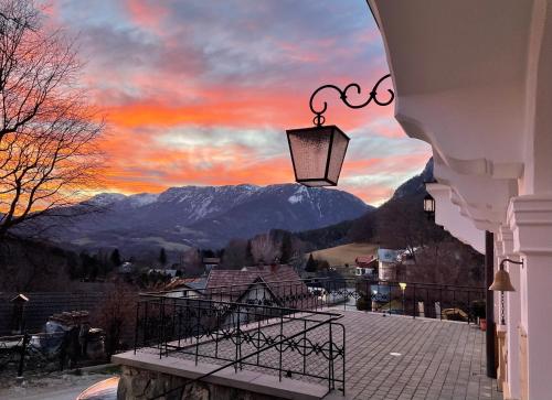 a view of a sunset from a balcony with a lamp at Waldschlössl Schneedörfl in Reichenau