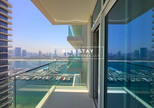 a balcony of a building with a view of a marina at Sunrise Bay 3BR EMAAR Beachfront Dubai Harbour by Rich Stay in Dubai