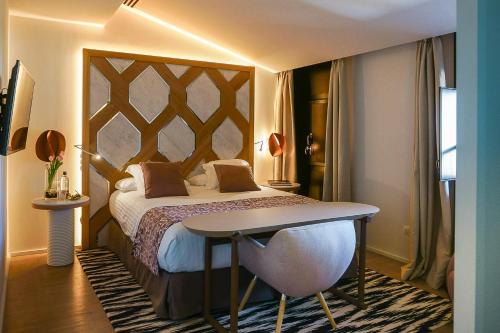 a hotel room with a bed and a table at Hospes Maricel y Spa, Palma de Mallorca, a Member of Design Hotels in Cas Catala