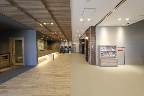 a hallway of a building with at Dormy Inn Maebashi in Maebashi