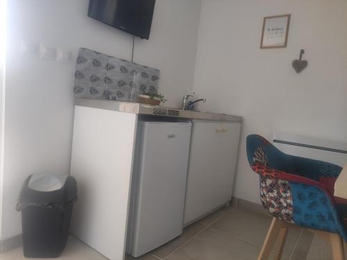 une petite cuisine avec un évier et un comptoir dans l'établissement le petit cocon, à Montbozon