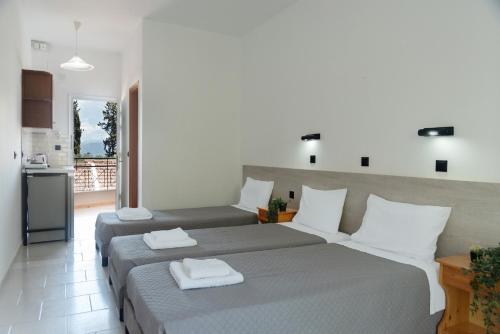 a bedroom with two beds with towels on them at Calypso Resort Kavos in Kavos