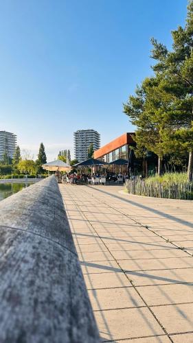 a walkway in a park with trees and a building at AMAO Green - City Center - Penthouse Maisonette - 90 m2 - 8 Guests - Rooftop Terrace - King-Size Beds in Lahr
