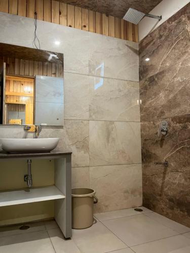 a bathroom with a sink and a shower at Qcent Woods Resort & Spa, Rishikesh in Rishīkesh