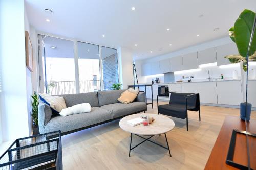 a living room with a couch and a table at Modern & charming home in Hackney in London