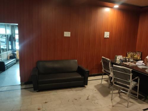 a waiting room with a black chair and a counter at hotel sunny international in Jammu