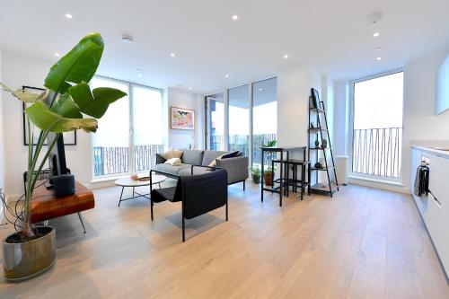 a living room with a couch and a table at Modern & charming home in Hackney in London