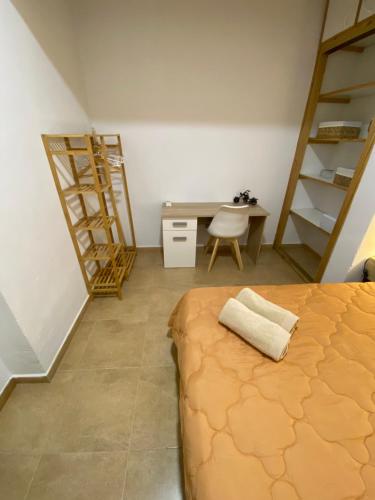 a bedroom with a bed and a desk and a table at Casa Rural Abuelo Raimundo in Ossa de Montiel