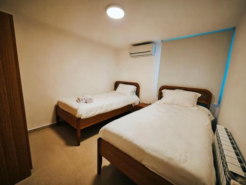 a small room with two beds in it at Beit Mema in Aḑ Ḑahr