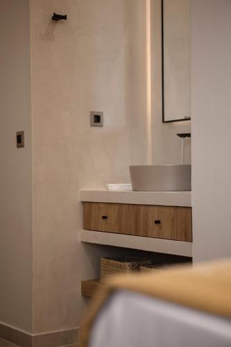 a bathroom with a sink and a white counter at Chrissida Hotel in Nea Kydonia