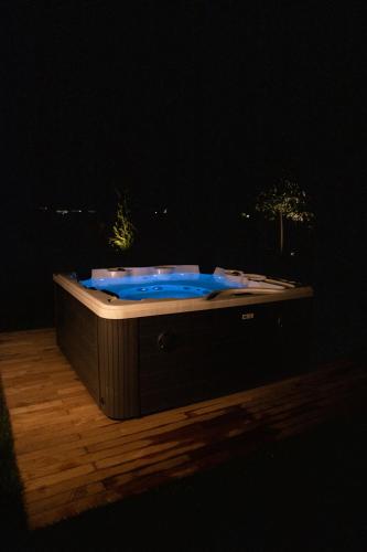 a hot tub with blue lights on a wooden floor at Agriturismo Borgonuovo in Rimini
