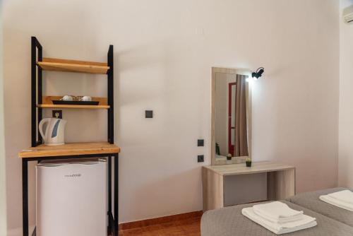 a room with two beds and a mirror at Calypso Resort Kavos in Kavos