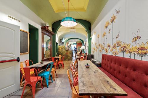 a restaurant with a wooden table and chairs and tables at Ostello Bello Firenze in Florence
