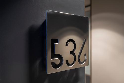 a sign with the number on a wall at Hotel Verona in Verona