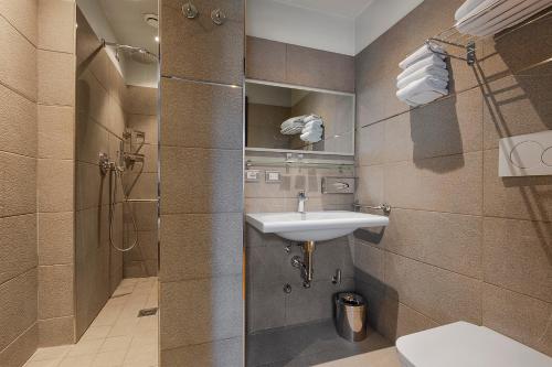 a bathroom with a sink and a shower at Hotel Verona in Verona